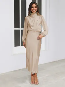 Full view of champagne satin long sleeve dress showing elegant drape and texture