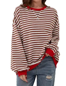 Close-up detail of a casual striped long sleeve crew neck t-shirt with red ribbed cuffs