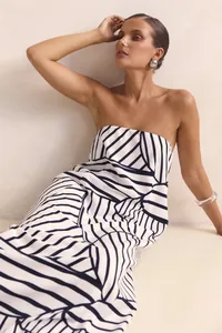 Detail of a strapless black and white geometric print summer maxi dress on a model.