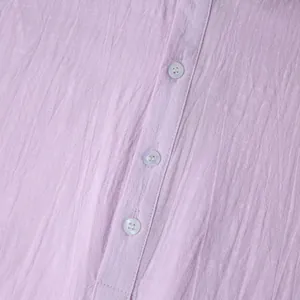 Macro close-up view of light purple cotton linen shirt fabric texture with buttons
