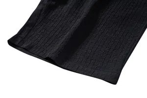 Detailed close-up of the black jacquard fabric texture on men's casual summer set hemline