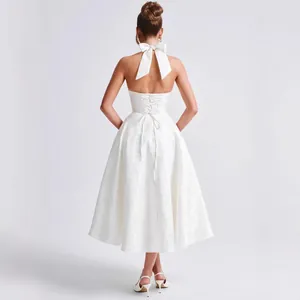 Elegant white jacquard halter dress featuring a backless lace-up detail and a bow