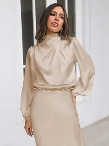 Elegant champagne satin long-sleeve dress with mock neck for formal evening occasions.
