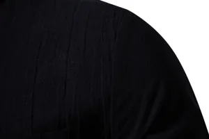 Macro detail of the breathable black linen fabric texture on a men's long-sleeve shirt