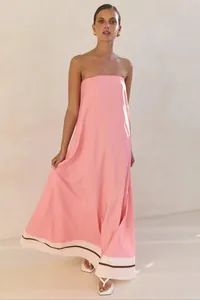 Elegant pink strapless maxi dress with striped hem detail for chic summer fashion
