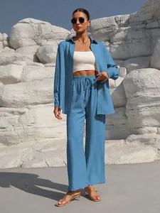 Stylish blue two-piece set featuring long-sleeved shirt and wide-leg trousers for women