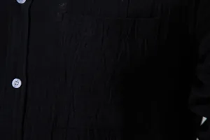 Close-up detail of breathable black cotton linen shirt fabric texture and pocket