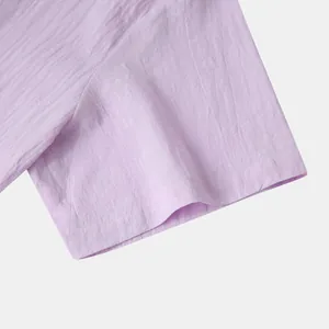 Close-up detail of breathable cotton linen fabric and sleeve stitching on a purple casual shirt