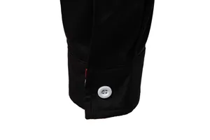 Detailed close-up view of a black men's long-sleeve shirt cuff with a white button.