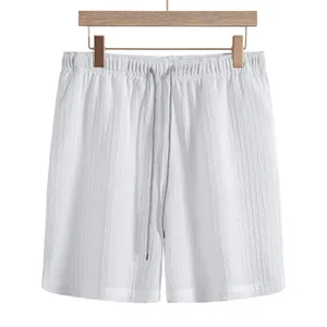 Close-up view of white men's casual jacquard shorts featuring a grey drawstring and elastic waist.