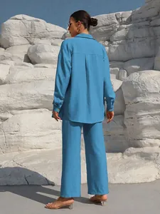 Back view of blue two-piece casual set with long sleeve shirt and wide-leg trousers