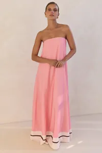 Full detail view of a pink strapless maxi dress with contrast white and black hemline