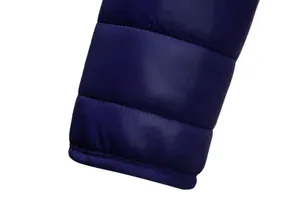 Detailed close-up of the elastic cuff on a navy blue men's winter padded jacket