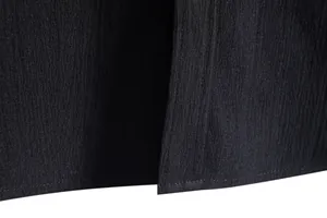 Close-up macro shot of black casual shirt fabric showing rich texture and stitching details.
