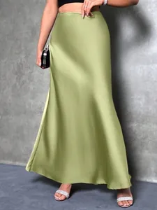Detail of elegant olive green satin midi skirt with silky texture and soft drape.