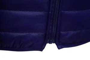 Close-up detail of a navy blue lightweight quilted jacket featuring a durable front zipper