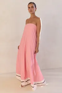 Full view of elegant pink strapless maxi dress with contrast hem border on a model