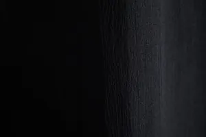 Macro view showing the high-quality black fabric texture of the men's casual shirt