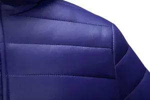 Macro view of horizontal quilting on a blue men's lightweight winter puffer jacket