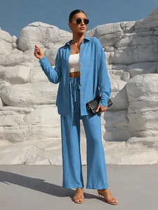 Full body view of a sky blue two-piece linen-style shirt and wide-leg pants leisure set.