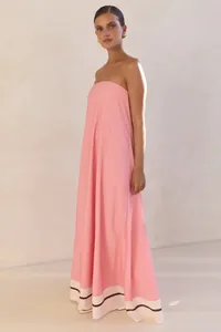 Elegant pink strapless maxi dress with decorative hem border shown on a model