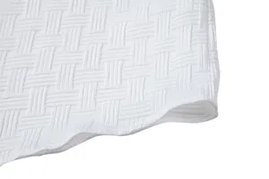 Macro view showing the intricate woven texture of the white ethnic style shirt fabric