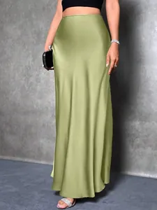 Detail view of lime green satin midi skirt with elegant silky sheen and high waist.