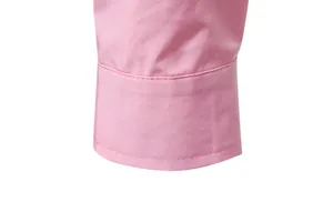 Detail of pink men's casual shirt cuff showing stitching and fabric texture