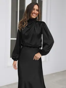Close-up detail of elegant black satin long sleeve evening dress featuring a draped neck