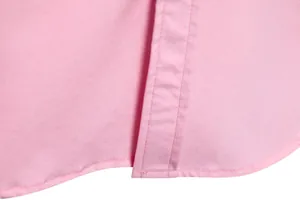 Close-up of the stitching and hem detail on a pink men's casual long-sleeve shirt