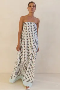 Detail view of a strapless maxi dress with a blue and brown geometric square pattern.