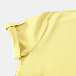 Primer plano detallado de la manga de una camisa de lino amarilla para hombre con vuelta