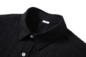 Close-up detail of black men's shirt collar showing textured grid fabric and M size tag info.