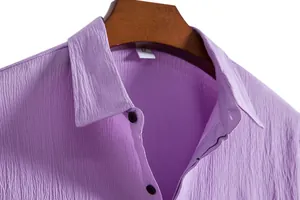 Close-up of purple men's shirt collar showing textured fabric and buttons