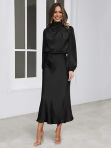Elegant black satin long-sleeved dress with high neck and flowing silhouette
