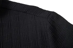 Close-up of the intricate black woven texture on the shoulder of the men's ethnic shirt.