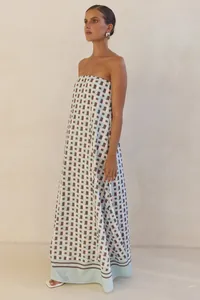 Detail shot of a summer strapless maxi dress featuring a blue and brown geometric print.