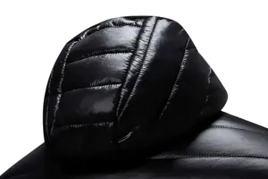 Detailed macro view of glossy black quilted hood texture on men's winter puffer jacket