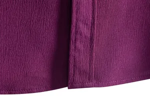 Macro detail of purple textured fabric showing neat stitching on a men's casual shirt
