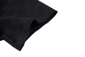 Macro detail of the high-quality black textured geometric pattern on men's shirt sleeve