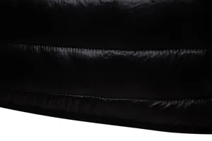 Macro detail of black quilted puffer jacket fabric showing shiny finish and stitching