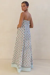 Elegant strapless maxi dress with geometric print and off-shoulder detail for summer.