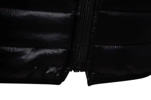 Close-up detail of the durable zipper and hem on a black lightweight padded jacket
