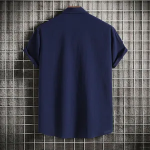 Back view of a men's loose-fit navy blue short-sleeve button-down shirt with textured fabric.