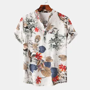 Detail view of white Hawaiian short sleeve shirt with colorful tropical leaf prints