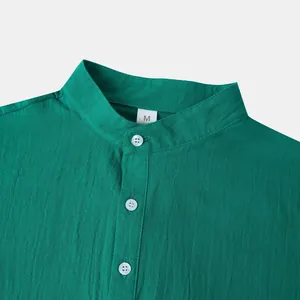 Close-up of men's emerald green linen shirt with mandarin collar and button detail.