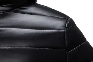 Close-up detail of shiny black quilted fabric and stitching on men's winter padded jacket