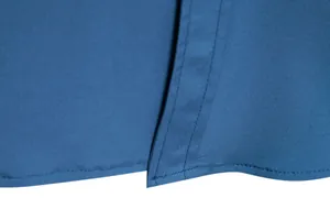Macro view of solid blue casual men shirt hem with fine double-stitching workmanship