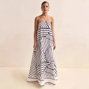 Elegant strapless maxi dress with a bold navy and white geometric striped pattern