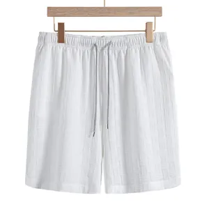 Detailed view of white men's textured waffle shorts with elastic drawstring waist